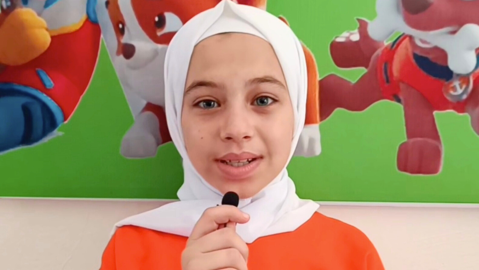 A smiling girl at the end of her educational journey at the Little Dreams Center.